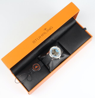 A gentleman's steel cased Stuhrling automatic wrist watch with visible movement on a rubber strap with steel clasp, boxed and with certificate 