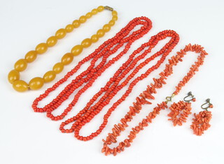 An amberoid bead necklace, a coral twig ditto, 2 other coral necklaces and a pair of coral earrings 