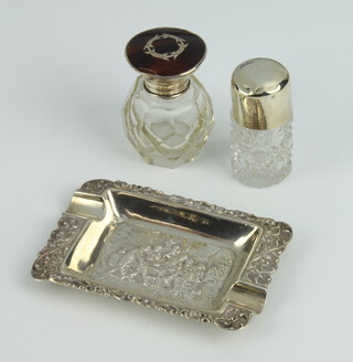 A silver and tortoiseshell mounted scent bottle, rubbed marks, dented top, a silver ditto and a white metal ashtray 