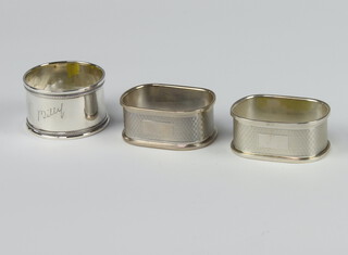 A pair of silver engine turned napkin rings Birmingham 1979, a single ditto, 38 grams