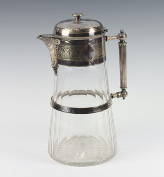 An Edwardian silver plated mounted jug with engraved formal decoration and glass body 30cm 