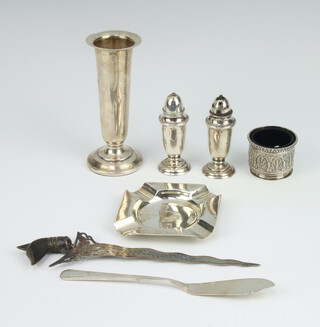 An octagonal silver ashtray Birmingham 1954, a spill vase, butter knife, pepperette and vase, weighable silver 132 grams 