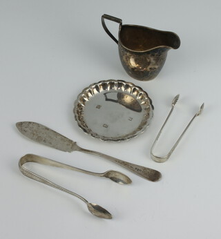 A silver dish Birmingham 1906, 2 pairs of sugar nips, a butter knife and a cream jug 128 grams 