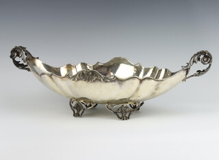 A Continental white metal fancy table centrepiece with acanthus handles and shell decoration on shell feet 48cm, 1024 grams 