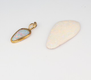A loose unmounted opal 35mm  x 18mm together with a yellow metal 14k mounted opal pendant 25mm 