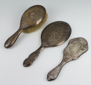 A silver hammer pattern brush and hand mirror rubbed marks and a brush back 