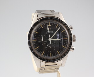 Omega, a gentleman's steel cased Omega Speedmaster chronograph manual wristwatch with black tachymetre bezel, having a black dial with 3 subsidiary dials for seconds, 30 minutes and 12 hour registers with fluorescent batons and white fluorescent hands, contained in a 40mm screw back case with Speedmaster emblem and Omega crown on an Omega Speedmaster bracelet no. 7912 