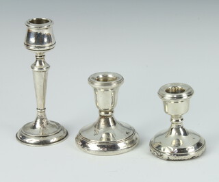 A stylish silver candlestick, Birmingham 1924 13cm, two dwarf ditto, rubbed marks