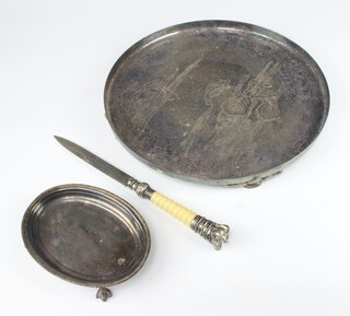 A circular silver plated tray with engraved floral decoration 30cm, an oval stand and a mounted paper knife 