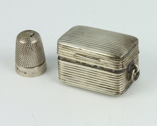 A Georgian silver rectangular reeded vinaigrette (lacking grill) rubbed marks and a silver thimble 32 grams