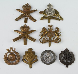Two Machine Gun Corps cap badges, a Royal Marine Light Infantry Cap badge, a Ypres Regt. Cap badge, a Canadian Royal 22nd Regt. cap badge, 2 other cap badges and a First World War discharge badge 