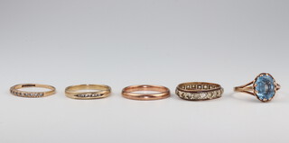 Four  9ct yellow gold rings and a ditto topaz ring, all size M, 8 grams gross