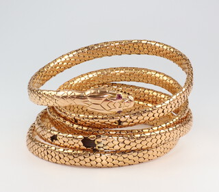 A Victorian yellow metal sprung snake bracelet with ruby eyes, gross weight including spring 51 grams 