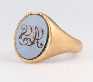 A gentleman's yellow metal hardstone signet ring with engraved monogram, gross weight 10 grams, size V 1/2