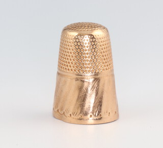 A yellow metal engraved thimble with monogram 3.7 grams 