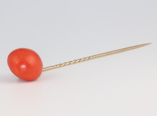 A coral tie pin with yellow metal stem, gross 4.2 grams, 8cm 
