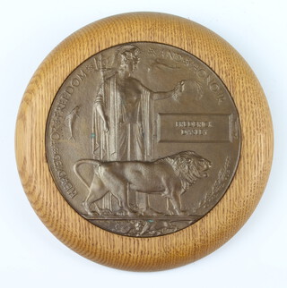 A First World War memorial death plaque to Frederick Dasley in an oak frame 
