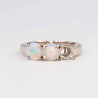An 18ct yellow gold ring shank with 2 (ex 3) opals, size L Â½,  gross weight 6 grams 