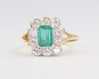 A yellow metal 18ct emerald and diamond ring the centre stone 1.1ct, the 10 brilliant cut diamonds 0.9ct, size N 1/2, 4 grams