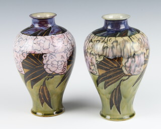 A pair of Royal Doulton oviform vases decorated with stylised flowers 24cm 