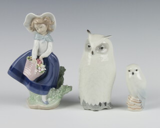 A Royal Copenhagen figure of an owl no.55, 16cm, a ditto of a baby owl 8.5cm and a Lladro figure of a girl holding a basket of flowers 19cm 