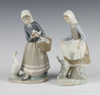 A Lladro figure of a goose girl and a Lladro figure of a girl with a rabbit at her feet both 23cm 