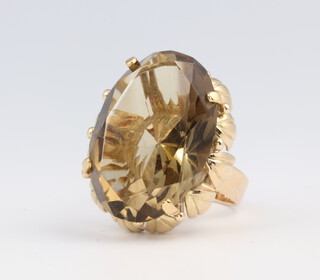 A yellow metal 14ct oval smoky quartz ring, 16.5 grams 
