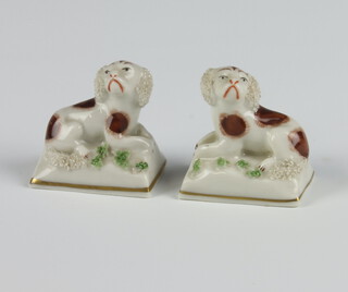 A pair of 19th Century Sampson figures of spaniels on cushions 4.5cm 