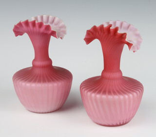 A pair of Victorian pink glass vases with wavy rims 16cm 