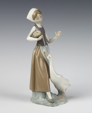 A Lladro figure of a goose girl 23cm 