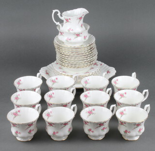 A Richmond Rose Time pattern part tea set comprising 12 tea cups, milk jug, sugar bowl, 12 saucers, 6 side plates, sandwich plate 