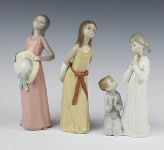 A Lladro group of 2 children playing 23cm, a ditto of a lady carrying a hat behind her 24cm and a lady holding a hat in front of her 24cm 