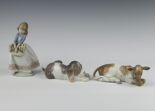 A Lladro figure of a reclining calf 16cm, ditto puppy 17cm and a girl carrying a basket of flowers (broken hand) 15cm 
