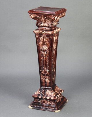 A Victorian brown glazed jardiniere stand of tapered form with eagle and figural decoration 97cm 