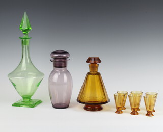 An Art Deco amber glass liqueur set with tapered decanter and 6 tapered totts (chipped stopper), a green glass bottle on square base (chipped base and stopper) and an amethyst glass ewer and stopper