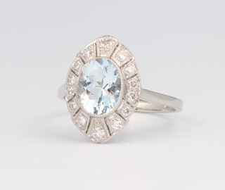 A white metal stamped Plat elliptical aquamarine and diamond ring, the centre stone 1.5ct, the diamonds 0.35ct, 6 grams