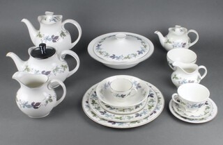 A Royal Doulton burgundy tea, coffee and dinner service comprising 6 coffee cups, 9 saucers, 8 tea cups (1 cracked), 14 saucers (1 chipped), teapot (lid replaced and damaged), coffee pot and breakfast teapot (chipped lid), milk jug, cream jug (cracked), sugar bowl, 19 small plates, 3 side plates, 11 medium plates, 12 dinner plates (1 cracked), 6 soup bowls, 10 dessert bowls, 2 sauce boats and stands, a sandwich plated, 3 oval meat plates, 2 tureens (1 cracked) and covers and a tureen lid   