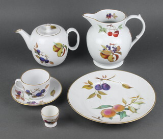 A Royal Worcester Evesham service comprising 6 dinner plates, 9 side plates, 7 small plates, a tea pot, 6 tea cups, 6 saucers, 8 dessert bowls, 10 ramekins, 2 flan dishes, 3 small dishes,, 4 small bowls, 4 avocado dishes, a sauce boat and stand, 5 soup bowls, a large jug, a casserole and cover, 1 pie dish, a souffle dish (A/F), 3 tureens and covers (1 A/F), 4 oval vegetable dishes and a deep bowl.