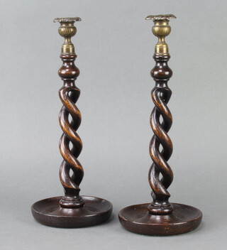 A pair of 1930's spiral turned oak candlesticks with metal sconces 37cm h x 14cm 