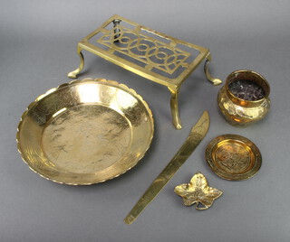 A Victorian rectangular brass footman, raised on cabriole supports 10cm h x 26cm w x 15cm (old repair), an Eastern engraved brass bowl 28cm, an embossed brass vase 10cm x 9cm, an Egyptian circular ashtray, a brass ashtray, a clover shaped ashtray and a Japanese brass letter opener 32cm (no handle)