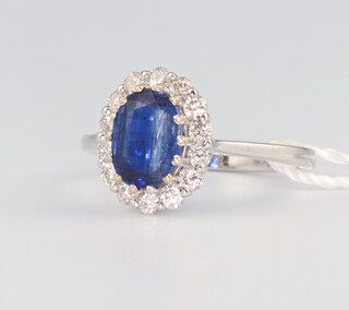A white metal stamped 18ct oval kyanite 1.77ct and brilliant cut diamonds 0.52ct cluster ring with WGI certificate, 3.5 grams, size M 1/2