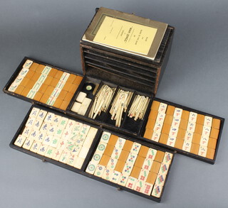 A bone and bamboo Mahjong set contained in a wooden complete with instructions 