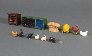 A Britain's model of a beehive, haystack, 2 chickens and a feeding bowl, cockerell, rabbit hutch 4 rabbits and a cat 