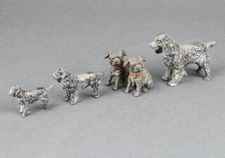 A 1930's cast metal figure of a standing spaniel 5cm x 5cm x 3cm, 3 other figures of spaniels and ditto figure of a pair of pugs 4cm x 3cm x 4cm 