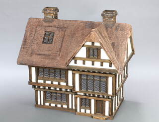 Robert Stubbs, a doll's house in the form of a Tudor half timbered house 89cm h x 93cm w x 60cm d together with a collection of dolls house furniture 