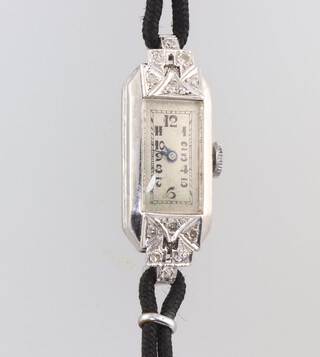 An Art Deco platinum diamond set cocktail watch 32mm x 10mm on a silk strap 