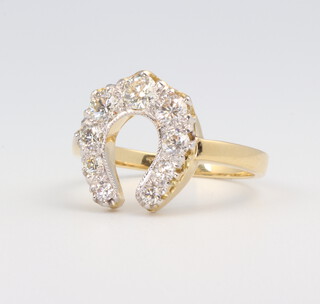 A yellow metal 18ct horseshoe diamond ring 0.9ct, size N 