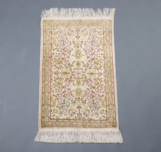 A white and green ground North West Persian silk rug with floral decoration within a 4 row border 82cm x 53cm 