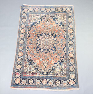 A blue and red ground Persian rug with central medallion with a 3 row border 196cm x 128cm 