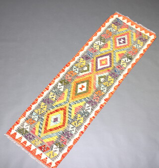 A white, green and purple ground Chobi Kilim runner with 4 geometric design and 4 diamonds to the centre 193cm x 61cm 